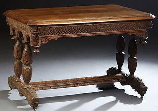 French Provincial Henri II Carved Oak Library Table, c. 1880, the stepped octagonal top over leaf carved skirts, on double urn trestle supports joined