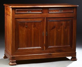 French Louis Philippe Carved Walnut Sideboard, 19th c., the canted corner rounded edge plank top above two frieze drawers over double cupboard doors, 