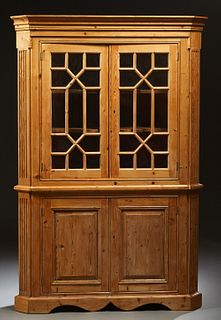 English Carved Pine Corner Cabinet, late 19th c., the stepped canted corner crown over double mullioned glazed doors, flanked by canted reeded pilaste