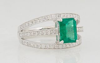 Lady's Platinum Dinner Ring, with a central 1.61 ct. emerald atop a wide triple split band mounted with small round diamonds, total diamond wt.- .6 ct