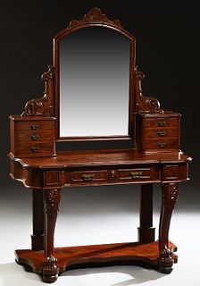 Victorian Carved Mahogany Dressing Table, late 19th c., the arched tilting mirror with a shell carved crest, on scrolled acanthus leaf supports on ban