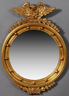 American Federal Style Carved Gilt Bullseye Mirror, 20th c., with a spread eagle atop a leaf and berry surmount, over a convex mirror, flanked by thir