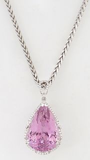 14K White Gold Pendant, with a pear shaped 56.2 carat kunzite atop a shaped border of small round diamonds, suspended from a pierced diamond mounted p