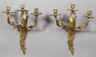 Pair of French Louis XV Style Three Light Sconces, 20th c., the swirling leaf and C-scroll back plates issuing three swirling leaf form arms with pier