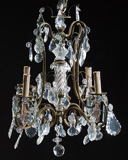 Brass Louis XV Style Four Light Chandelier, 20th c., the four double scrolled arms hung with pendalogue and button prisms, around a central swirled gl