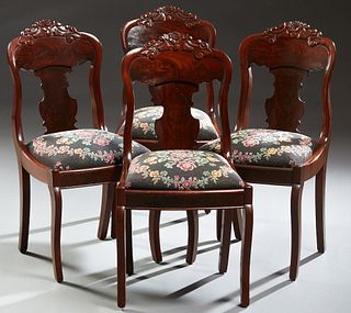 Set of Four American Classical Carved Mahogany Dining Chairs, c. 1910, the arched floral carved crest rail, over a curved back with a vasiform splat, 