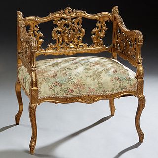 Louis XV Style Gilt and Gesso Wood Vanity Bench, late 19th c., the C-scroll carved crest rail, over a pierced C-scroll back flanked by winged gryphon 