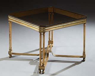 Brass Plated Glass Top Coffee Table, 20th c., the octagonal smoked glass top over a reeded skirt, on four double octagonal columnar supports, joined b