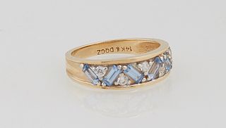 Lady's 14K Yellow Gold Dinner Ring, with six diagonally mounted baguette pale blue sapphires, separated by 5- two point diamonds, total diamond wt.- .
