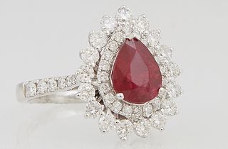 Lady's Platinum Dinner Ring, with a pear shaped 1.69 carat ruby atop a double concentric border of round diamonds, the shoulders of the band also moun