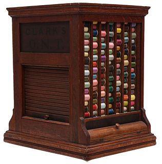 A CLARK'S O.N.T. OAK SPOOL CABINET WITH ROLL FRONT