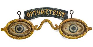 AN UNUSUAL OPTOMETRIST TRADE SIGN WITH EMBOSSED BANNER