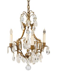 A Louis XV Style Gilt-Metal, Rock Crystal and Glass Four-Light Chandelier
Height 19 x diameter 13 inches.