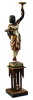 Unusual Venetian Carved and Polychromed Wood Blackamoor, 19th c., holding a torchere in her left hand and a card tray in her right, on a polychromed b