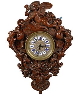 French Monumental Louis XV Style Carved Walnut Wall Clock, 19th c., the winged putto surmount over a time and strike steel face clock by Japy Freres, 