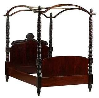 American Carved Pineapple Post Canopy Double Bed, late 19th c., the arched headboard with a central fruit basket crest, flanked by two large scrolled 