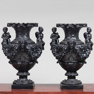 Large Pair of Ebonized Plaster Urns with Figural Handles