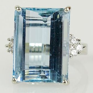 Lady's vintage aquamarine and 14 karat white gold ring accented with small round cut diamond ring.