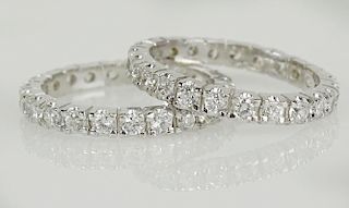 Pair of lady's approx. .75 carat round cut diamond and 14 karat white gold eternity bands.