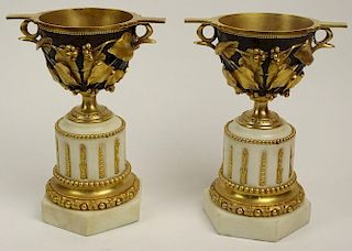 Pair of Antique Gilt and Patinated Bronze Urns on Marble Bases.