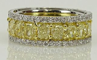 EGL certified 8.23 carat rectangular cut fancy intense yellow diamond and platinum eternity band.