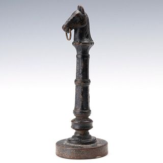 AN ANTIQUE MODEL OF CAST IRON HORSE HEAD HITCHING POST