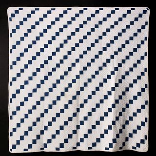 AN EARLY 20TH C. BLUE AND WHITE FOUR-PATCH QUILT