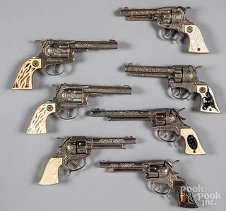 Seven toy cap guns