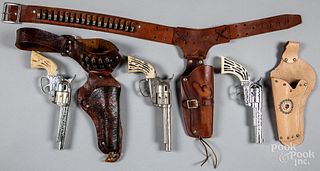 Three cap guns with holsters