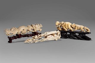 Lot of three ivory sculptures: a dragon, a shell with a female figure inside, an elephant with lion and monkey, early 20th century