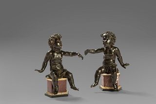 Pair of dark patina bronze putti, with non-coeval marble bases, Rome 17th century