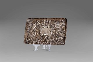Embossed silver tray with floral motifs, central mask and birds