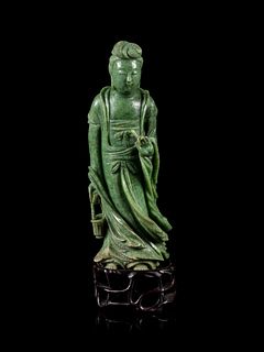 A Mottled Green Jade Figure of Guanyin
Height 6 1/2 in., 16.51 cm.