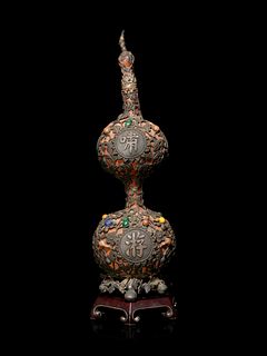 A Silver and Hardstone Mounted Double Gourd
Height 15 1/2 x width 4 1/2 in., 9.4 x 11.4 cm.