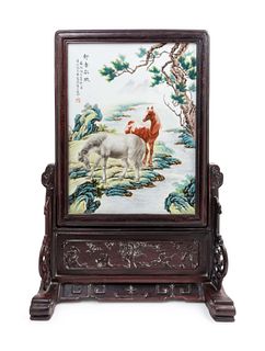 A Famille Rose Porcelain Inset Hongmu Table Screen
Height overall 27 1/2 x width 19 1/4 in., 69.85 x 48.9 cm
