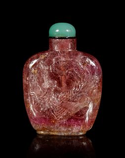 A Tourmaline 'Dragon and Phoenix' Snuff Bottle
Height overall 2 3/4 in., 5.8 cm.