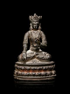 A Sino-Tibetan Bronze Figure of a Seated Crowned Buddha
Height 5 3/4 in., 14.6 cm.