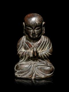 A Small Bronze Figure of a Seated MonkHeight 5 in., 12.7 cm.