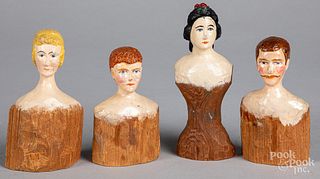Four carved and painted wood doll heads, 19th c.