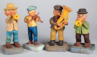 Four carved and painted musicians, 20th c.