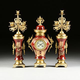 A THREE PIECE CONTINENTAL GILT BRONZE MOUNTED OX BLOOD RED PORCELAIN VASE CLOCK GARNITURE, LATE 19TH/EARLY 20TH CENTURY,