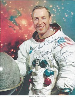 A PAIR OF NASA ASTRONAUT SIGNED PORTRAIT PRINTS, "James A. Lovell in his Spacesuit," CIRCA 1962, 