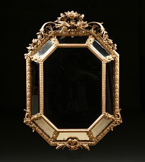 A REGENCE STYLE PARCEL GILT AND CARVED WOOD OCTAGONAL MIRROR, SECOND HALF 19TH CENTURY,