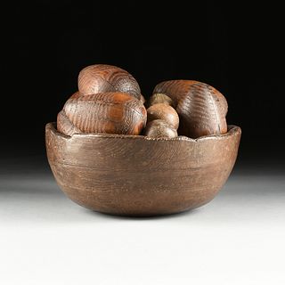 A COLLECTION OF ANTIQUE AMERICAN VARIOUS PRIMITIVE WOOD PEAR AND SPHERE FORM LAWN GAME PIECES, WITHIN A LARGE CARVED WOOD BOWL, 