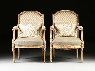 A PAIR OF LOUIS XVI STYLE FORTUNY UPHOLSTERED AND PARCEL GILT CARVED WOOD FAUTEUILS, LATE 19TH/EARLY 20TH CENTURY, 