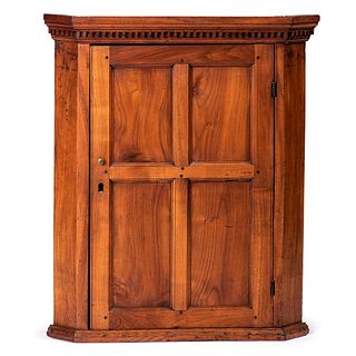 A Dentil Molded and Paneled Hanging Corner Cupboard in Cherry