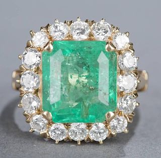7.55ct Emerald and diamond halo 14kt ring.