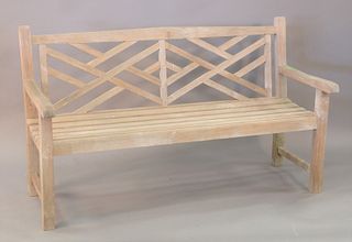 Teak bench with geometric back. ht. 36", wd. 62".