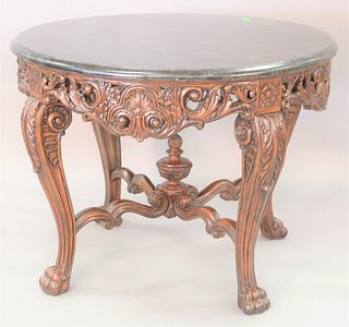 Round carved center table with veneer granite top, ht. 34", dia. 46".