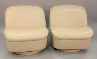 Pair directional leather swivel rocker armless chairs, ht. 31", wd. 32".